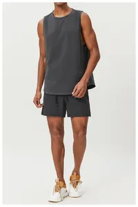 Full body view of a man wearing a breathable dark grey moisture-wicking sports tank top