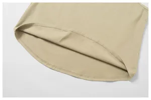Detailed close-up of neat stitching and curved hem on beige cotton athletic tank top