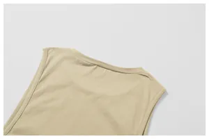 Detailed view of the reinforced neckline and shoulder seams of a beige sports tank top.