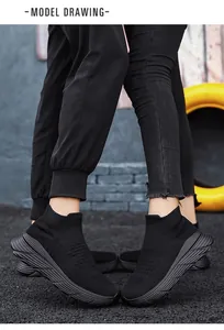 Détail de baskets en maille respirante noires avec semelles épaisses texturées dans la rue.