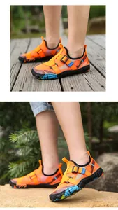 Detail view of orange outdoor water shoes for kids with non-slip soft rubber soles.