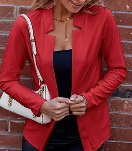 Close-up of a red open-front blazer with a unique notched collar and textured fabric.
