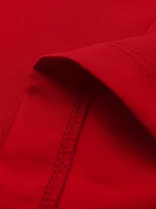 Macro view of red blazer fabric showing premium stitching and smooth texture details