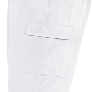 Gedetailleerde opname van een cargozak op een witte linnen broek met textuur