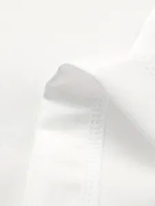 Macro detail of high-quality white blazer fabric texture and neat inner stitching seam.