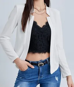 Close-up of elegant white open-front blazer paired with black lace top and layered necklace
