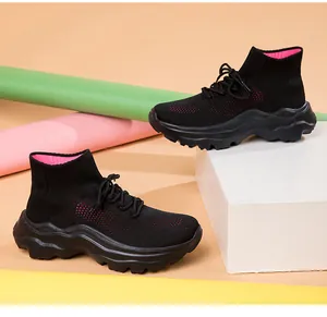 Side view of black and pink breathable knitted high-top sneakers with chunky soles