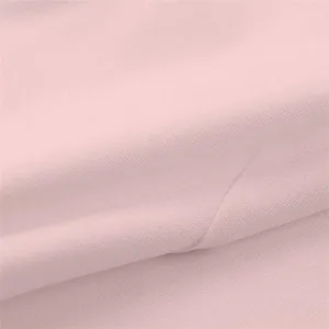 Close-up of premium soft pink fabric texture for elegant women's blazers and cardigans.