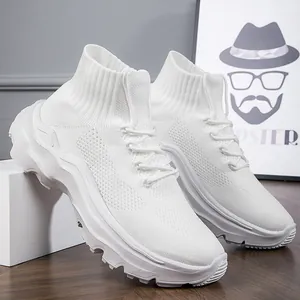 Detailed view of white breathable fly-knit high-top sneakers with thick wavy soles