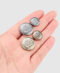 Detail showing premium metal blazer buttons with intricate embossed crest design