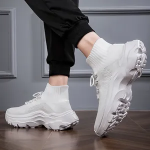 Side view of white breathable fly-knit high-top sneakers showing chunky sole detail