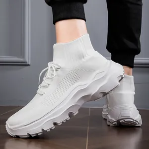 Detail view of breathable white high-top fly-knit sneakers with a chunky wavy sole