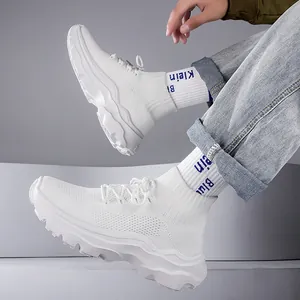 Close-up of white high-top fly-knit breathable sneakers with chunky sole design