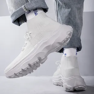 Close-up detail of white breathable fly-knit high-top sneakers with thick textured soles