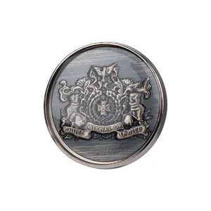 Antique silver metal suit button featuring an embossed royal crest and scroll design