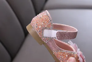 Detailaufnahme eines rosa Prinzessinnenschuhs für Mädchen mit funkelnden Strasssteinen.