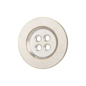 Premium silver metal four-hole button with subtle gold rim for high-end apparel