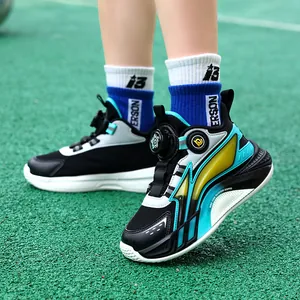 High-performance breathable boys basketball shoes with rotary buckle shown on green turf