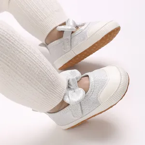 Detail view of silver glitter baby bow pre-walker shoes featuring non-slip soft rubber soles