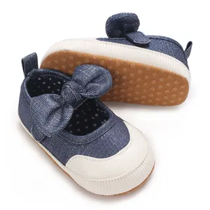 Close-up of navy baby girl walking shoes with classic bow and non-slip rubber dots on sole
