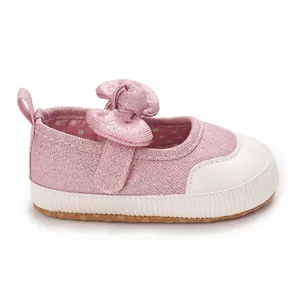 Detailed side view of pink baby girl pre-walker shoe with classic bow and non-slip sole