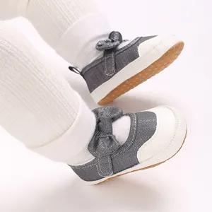 Detailed close-up of grey glitter baby pre-walker shoes with a cute bow accent