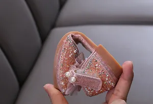 Close-up of the ultra-flexible tan sole on a pink sparkly rhinestone girl's princess shoe