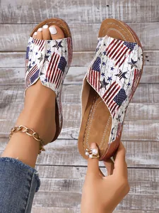 Detailed close-up of women's peep-toe slides with a vintage American flag print