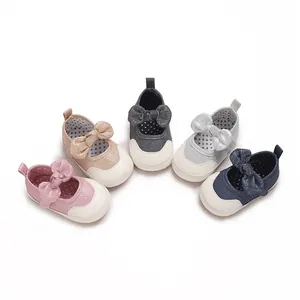 Close-up of sparkling baby girl pre-walker shoes with an elegant bow detail and white toe cap