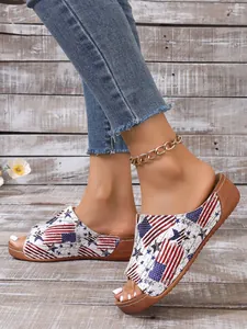Close-up view of women's peep toe wedge sandals featuring a stylish American flag print