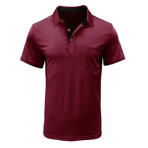Close-up detail of a burgundy men's polo shirt with chest pocket and contrast collar.