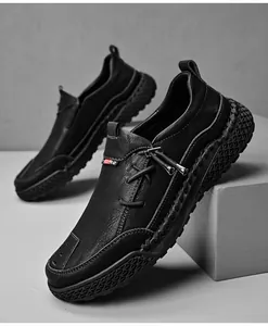 Detail view of black casual leather shoes featuring hand-stitched thick soles and slip-on fit.