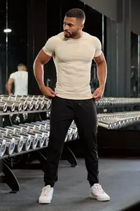 Detail of men's muscle fit high-elasticity sports t-shirt shown in gym environment