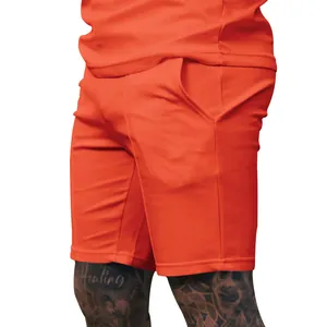 Macro view of men's orange ribbed golf shorts highlighting textured fabric and side pocket