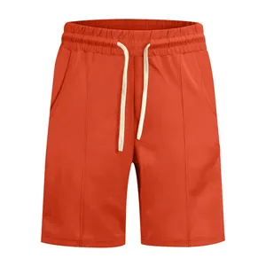 Detailed view of men's ribbed golf casual shorts in vibrant orange with drawstring waist