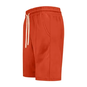 Detailed side view of orange men's golf shorts featuring elastic drawstring waist