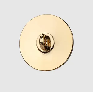 Detailed close-up view of the back shank on a circular polished gold metal button