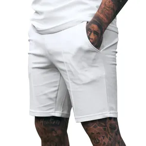 Detailed view of men's white solid color fitness sports shorts with side pockets