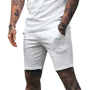Detail view showing the fit of men's white slim sports shorts for gym and casual wear