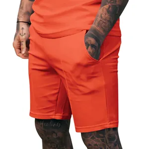 Detail view of men's bright orange casual sports shorts featuring side pockets.