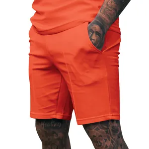Close-up of premium men's orange athletic shorts showing fabric texture and pocket detail