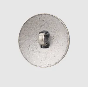 Detailed macro view of the shank back on a textured silver-finished thick copper button