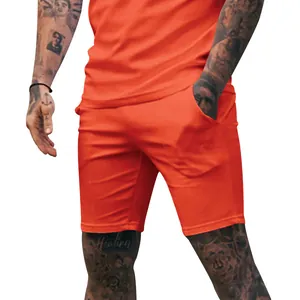 Detail view of men's solid orange athletic shorts for fitness and casual summer wear