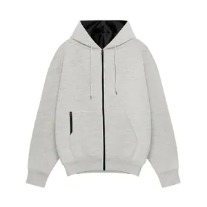 Detailed view of men's light gray zip-up hoodie with black hood lining and adjustable drawstring.