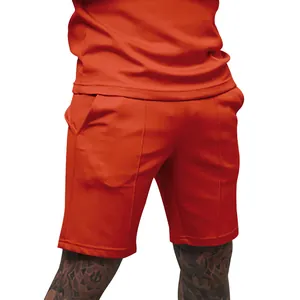 Close-up detail of men's orange casual athletic shorts with stylish seam accents and pockets