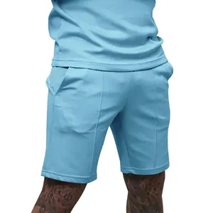 Close-up of front stitched seam and pocket detail on light blue men's fitness shorts