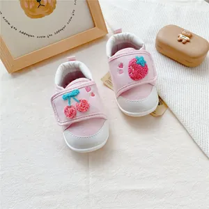 Detailed macro view of baby soft sole walking shoes with cherry and strawberry embroidery