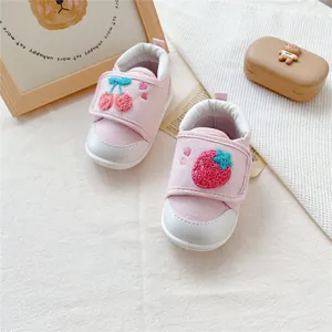 Cute pink baby walker shoes featuring lovely embroidered cherry and strawberry details