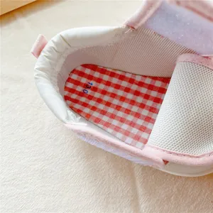 Detail view of baby walker shoe interior with soft lining and red checkered insole