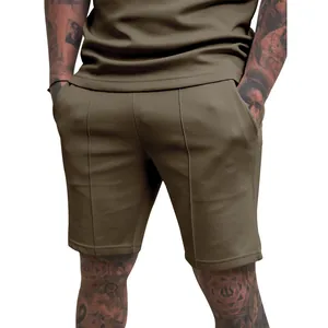 Detail view of men's olive green athletic shorts with seam design on fit model